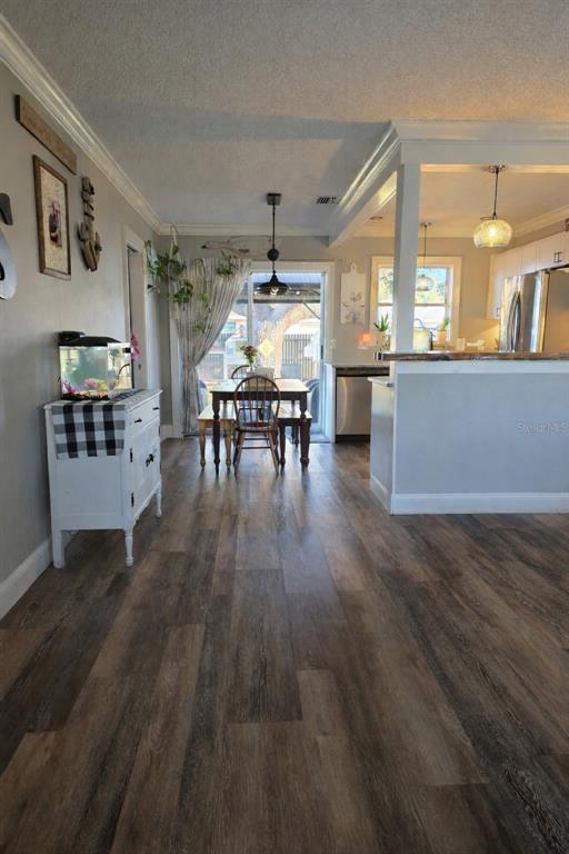 A dining area with a wooden table and chairs sits between a kitchen and patio — 441 CORONADO ROAD, VENICE, FL