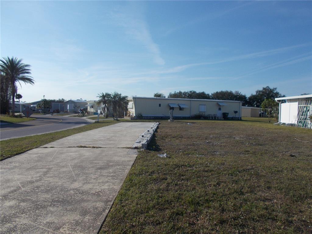 A vacant lot with a concrete driveway pad in a mobile home community — 6581 CENTER LANE, NORTH PORT, FL