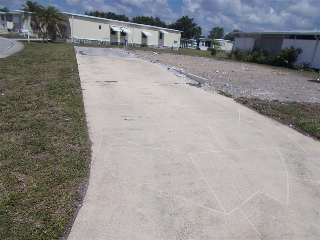 A concrete driveway leads to a vacant lot in a mobile home community — 6581 CENTER LANE, NORTH PORT, FL