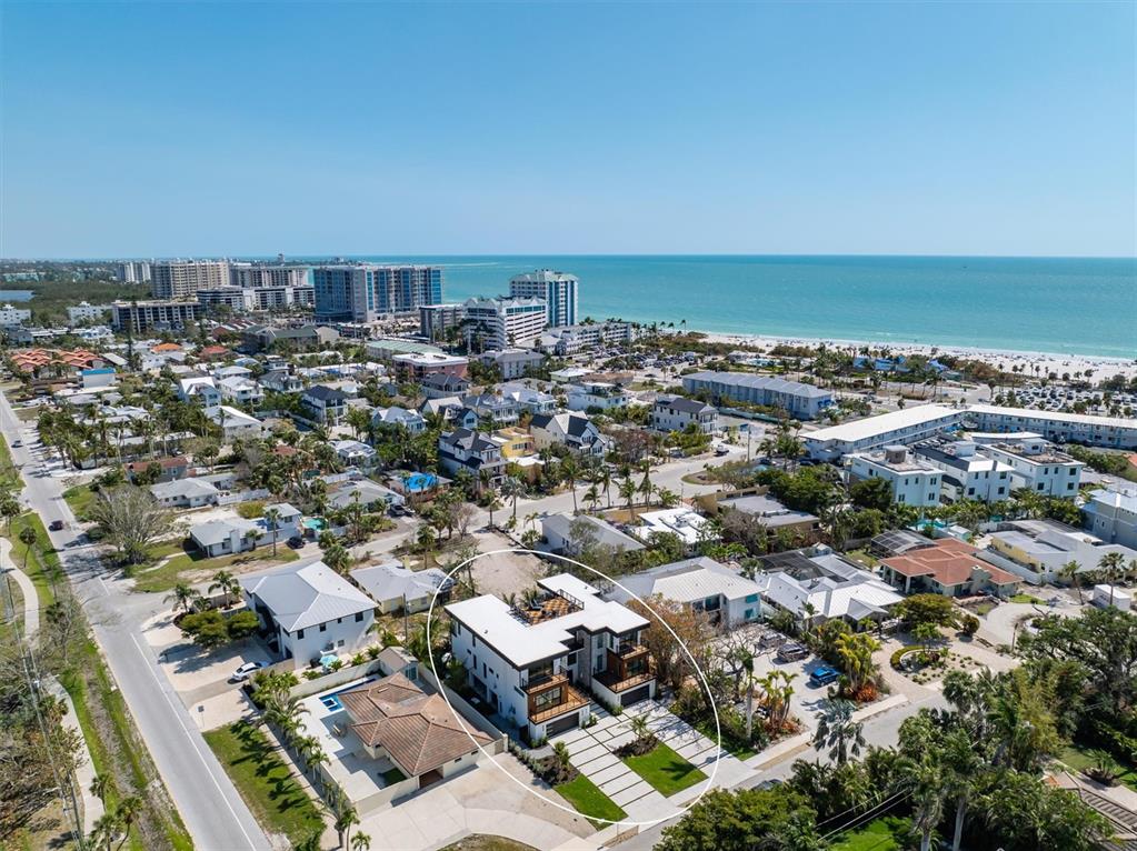 An aerial view shows a modern multi-story house with a flat roof and rooftop deck — 540 S POLK DRIVE, SARASOTA, FL