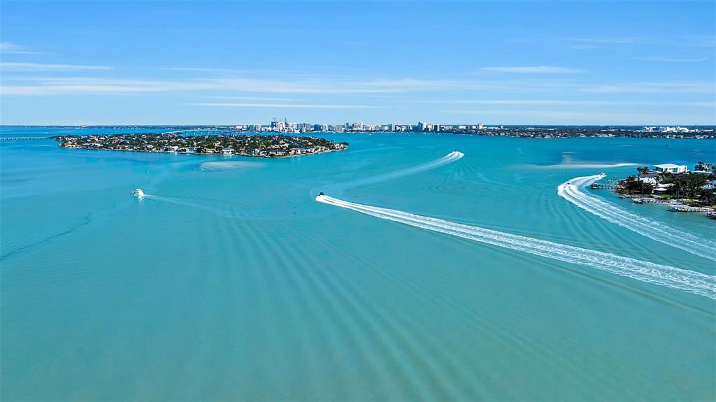 An aerial view of boats traveling through turquoise water near a coastal residential island — 540 S POLK DRIVE, SARASOTA, FL