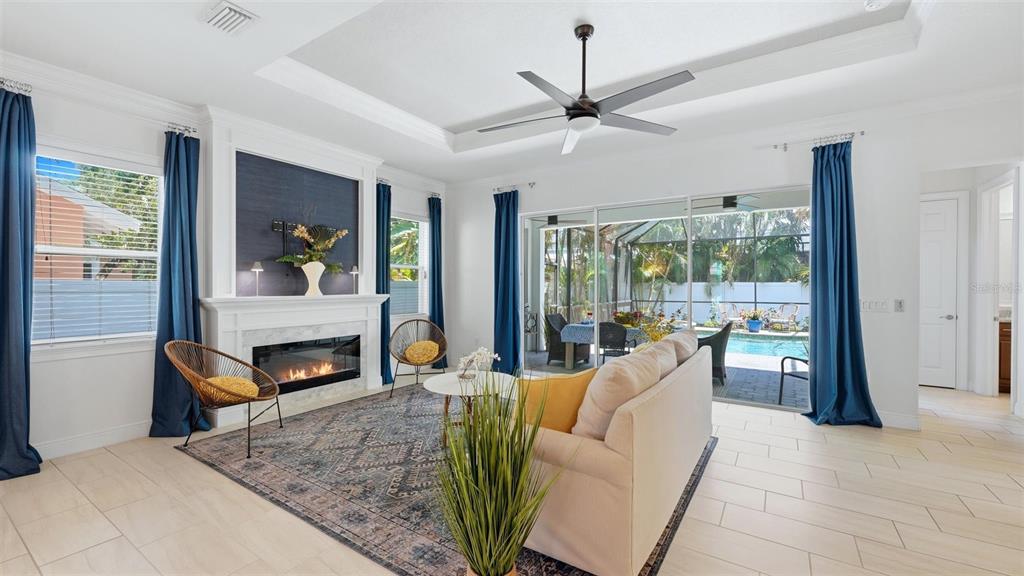 A two-story house with a white stucco exterior, stone accents, and a blue front door — 1850 MAGNOLIA STREET, SARASOTA, FL