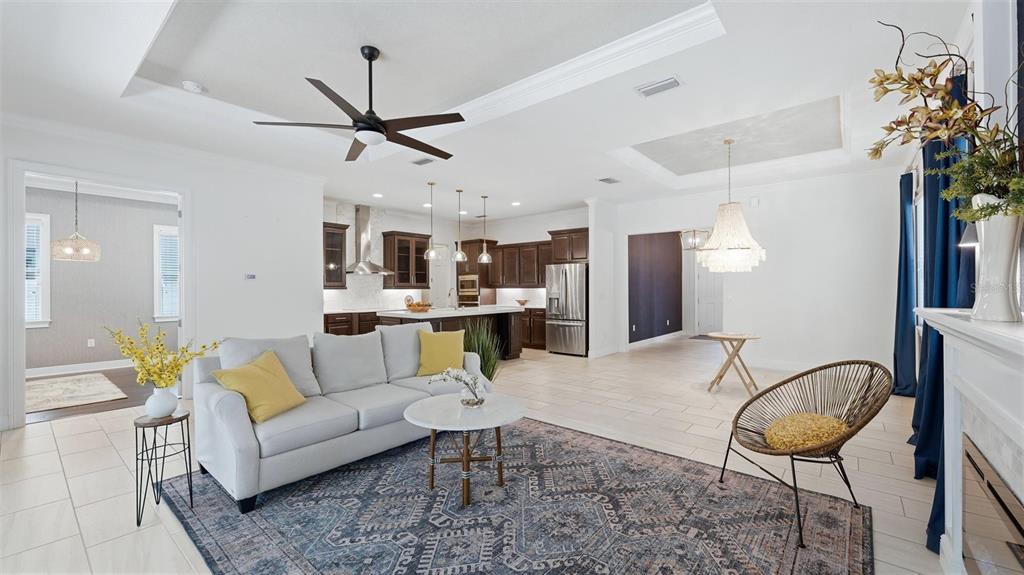 A covered patio features a dining set, a pool, and a spa inside a screened enclosure — 1850 MAGNOLIA STREET, SARASOTA, FL