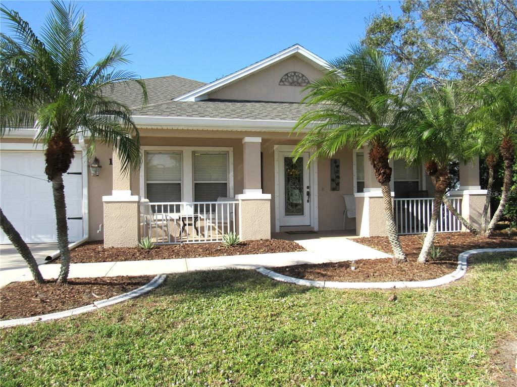 A single-story house with a front porch, palm trees, and a white garage door — 191 ALLWORTHY STREET, PORT CHARLOTTE, FL