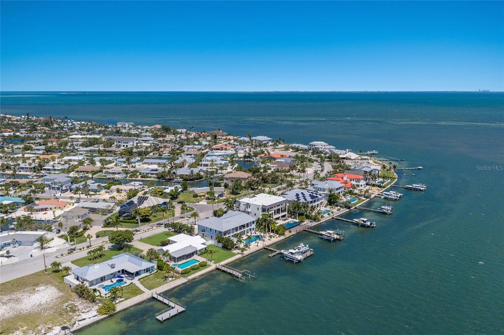 An aerial view shows waterfront homes with private docks along a coastal residential neighborhood — 633 KEY ROYALE DRIVE, HOLMES BEACH, FL