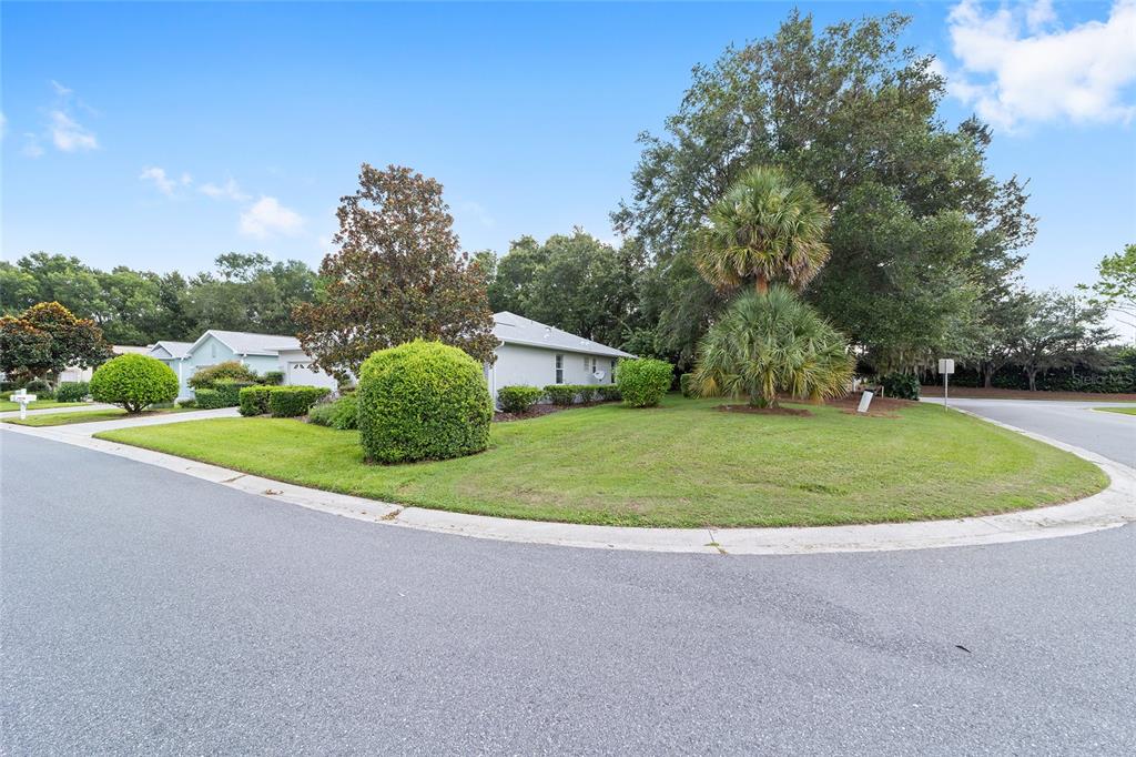 A single-story house with a light-colored exterior sits on a corner lot with landscaping — 8298 SW 79TH CIRCLE, OCALA, FL