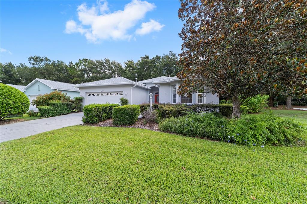 A single-story house with a gray exterior, a two-car garage, and a large front yard — 8298 SW 79TH CIRCLE, OCALA, FL