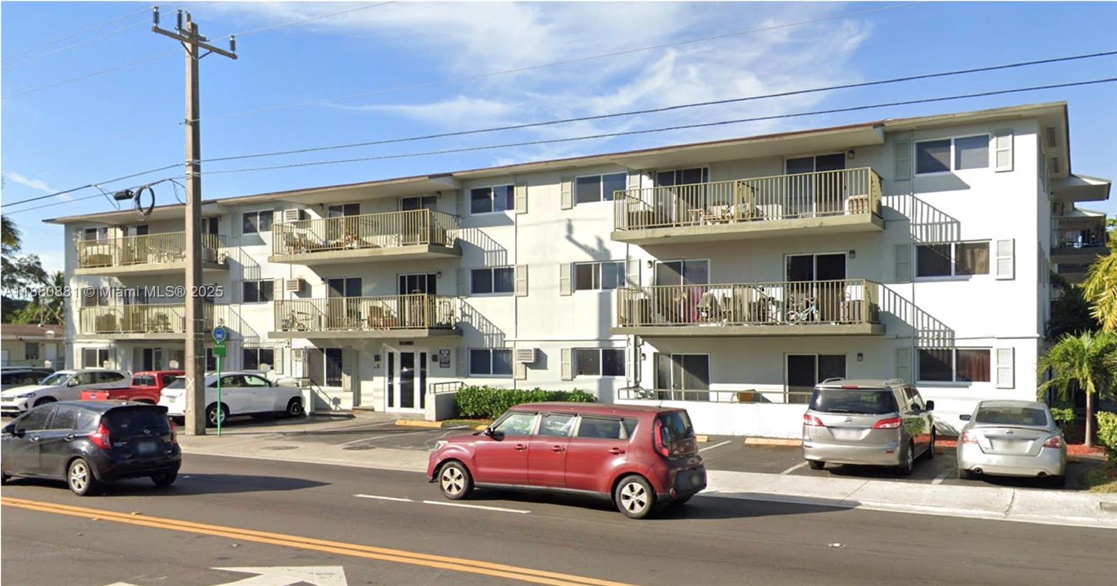 A three-story apartment building with balconies and a parking lot in front — 13285 NE 6th Ave # 301, North Miami FL 33161, NORTH MIAMI, FL