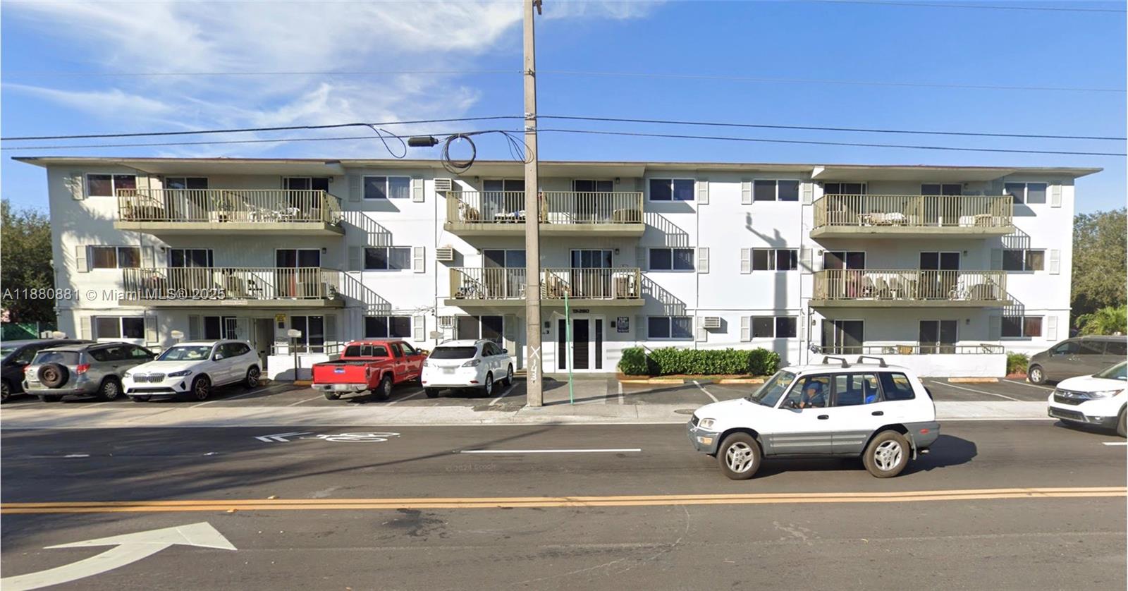 A three-story apartment building with balconies and a parking lot in front — 13285 NE 6th Ave # 301, North Miami FL 33161, NORTH MIAMI, FL