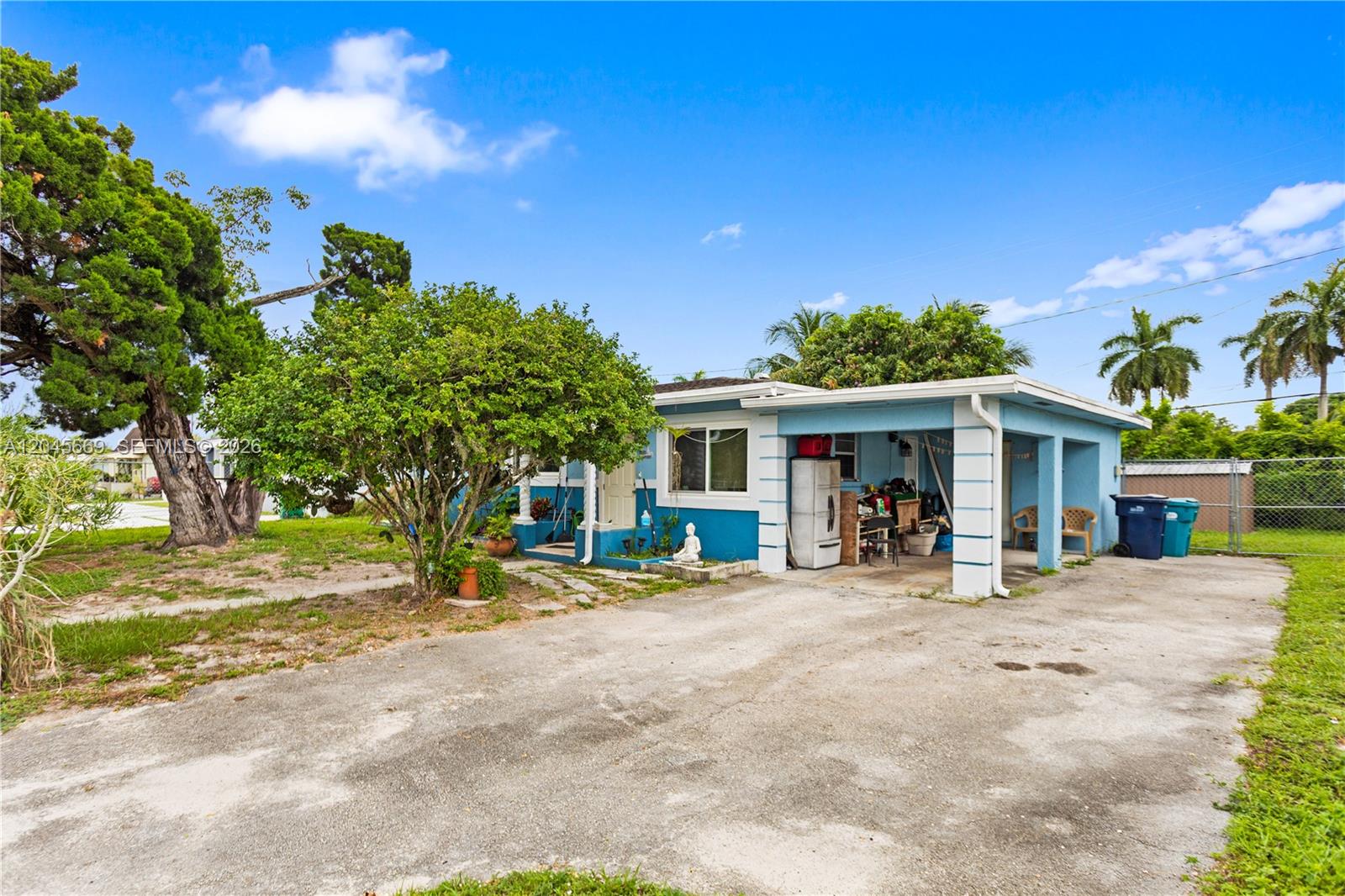A blue single-story house with a carport and a large tree in the front yard — 3030 NW 176th St, Miami Gardens FL 33056, MIAMI GARDENS, FL