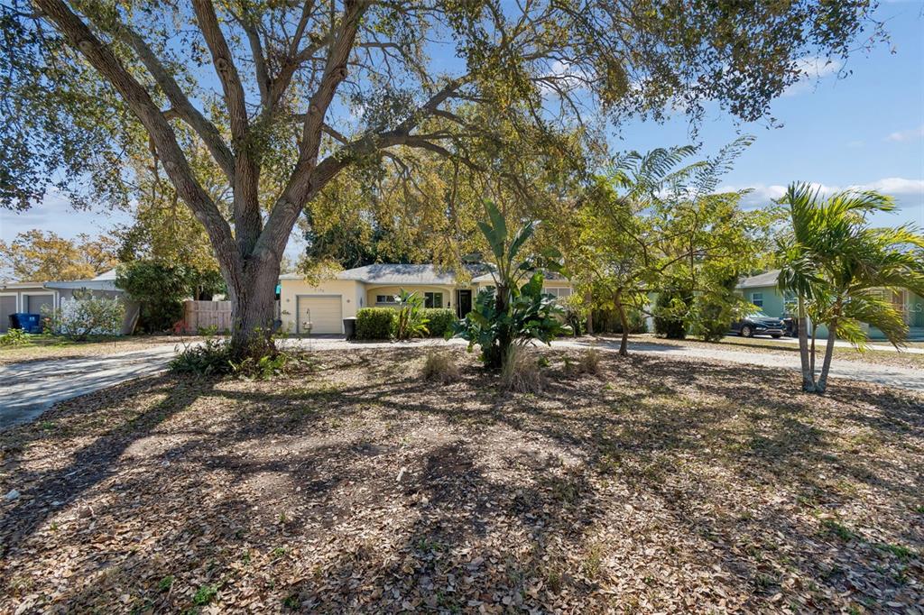 A single-story house with a garage and large trees in the front yard — 2120 CORONADA WAY S, ST PETERSBURG, FL