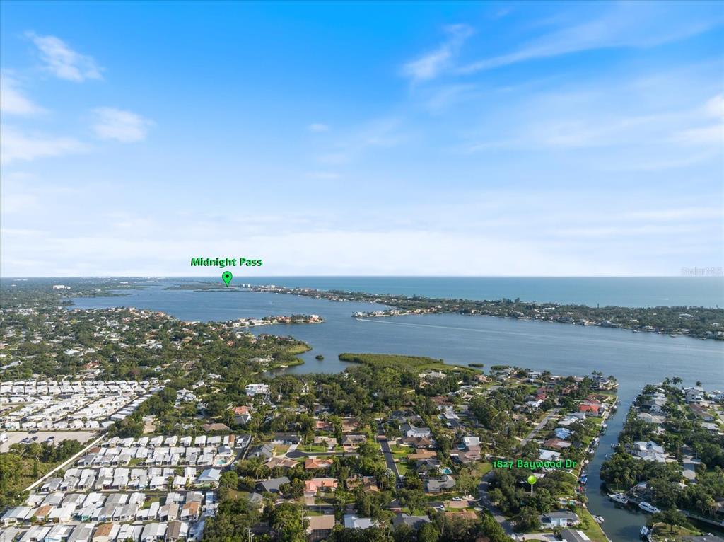 This aerial view shows a residential neighborhood near a waterway and the ocean — 1827 BAYWOOD DRIVE, SARASOTA, FL