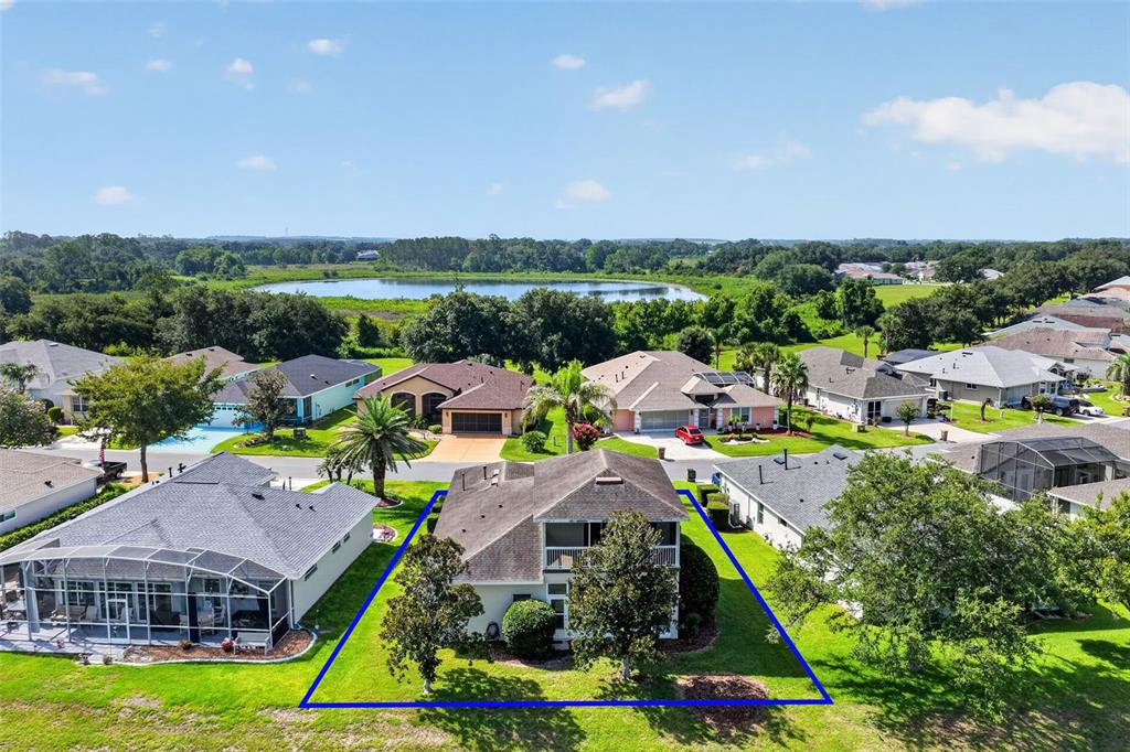 An aerial view shows a two-story house with a backyard enclosed by a blue outline — 5401 SIR CHURCHILL DRIVE, LEESBURG, FL