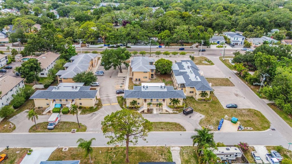 An aerial view shows a multi-building apartment complex with parking lots and surrounding trees — 2826 W RAINBOW CIRCLE UNIT 2818, SARASOTA, FL