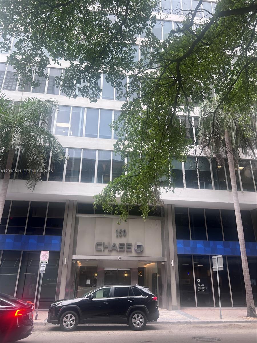 A black SUV is parked in front of a multi-story office building with Chase signage — 150 SE 2nd Ave # 208, Miami FL 33131, MIAMI, FL