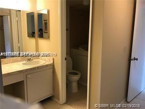 A bathroom features a vanity with a sink and a separate room with a toilet — 9470 Live Oak Pl # 306, Davie FL 33324, DAVIE, FL
