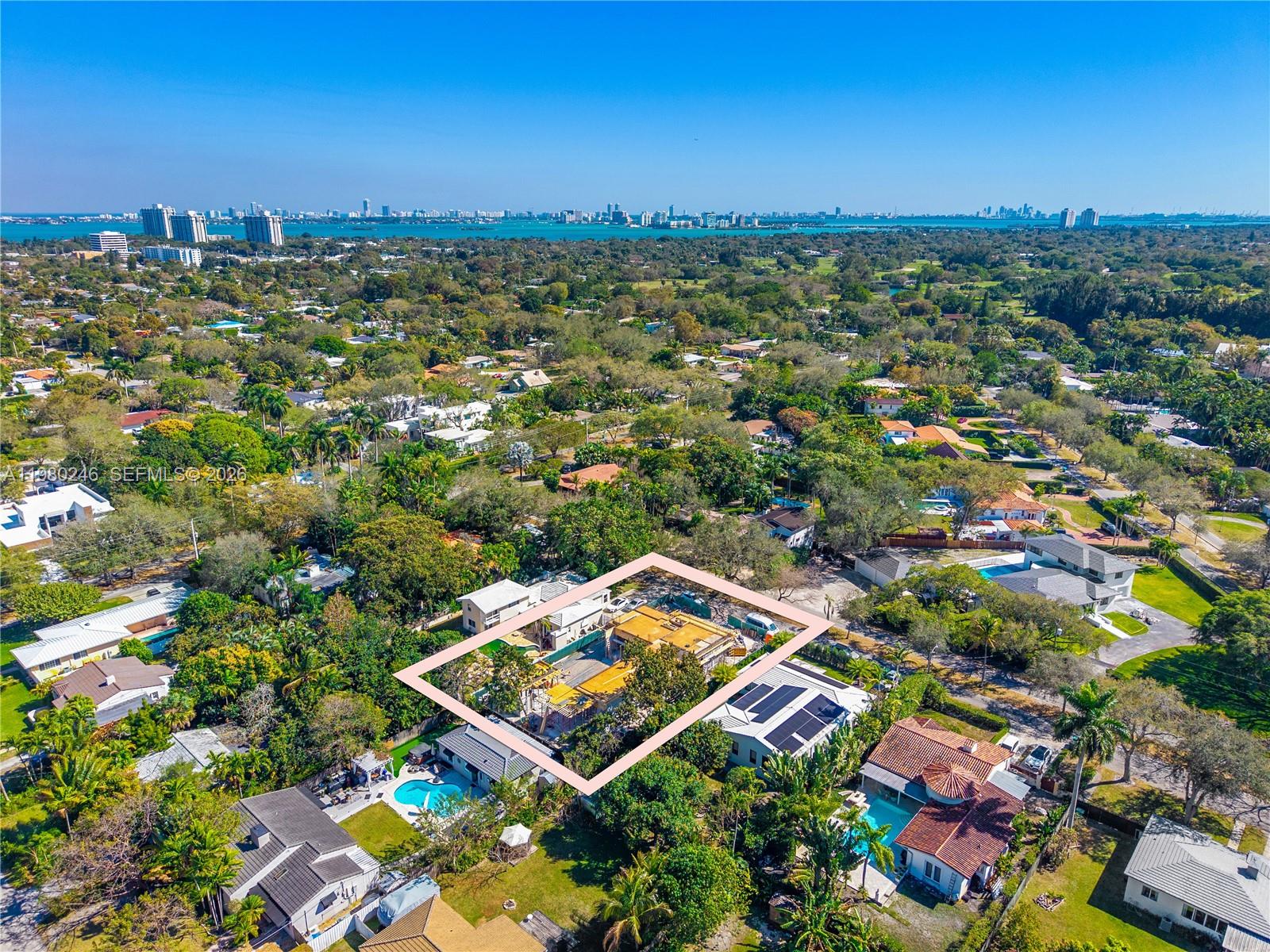 An aerial view shows a residential property under construction surrounded by lush trees and homes — 739 NE 111th St, Biscayne Park FL 33161, BISCAYNE PARK, FL