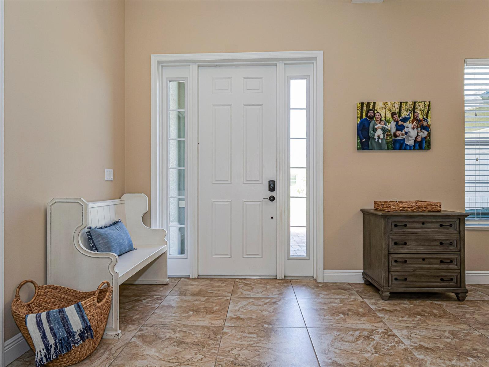 A foyer features tile flooring, a white front door with sidelights, a bench, and a dresser — 922 Yearling Trail, Sebastian FL 32958, SEBASTIAN, FL