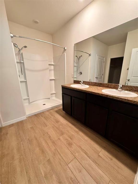 A bathroom features a double vanity with a granite countertop, dark cabinets, and a shower — 8244 SW 60TH ROAD, GAINESVILLE, FL