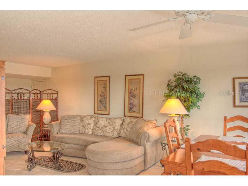 A living room features a sectional sofa, a glass coffee table, and a dining area — 131 GARFIELD DRIVE UNIT 4C, SARASOTA, FL