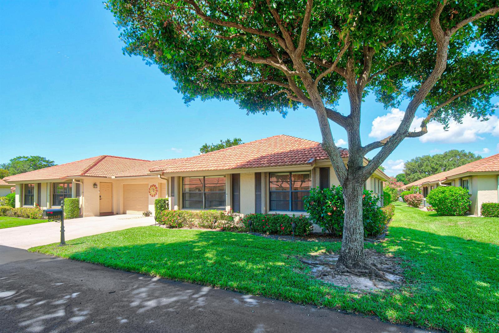 A single-story house with a tile roof and a large tree in the front yard — 9925 Frangipani Tree Way # B, Boynton Beach FL 33436, BOYNTON BEACH, FL