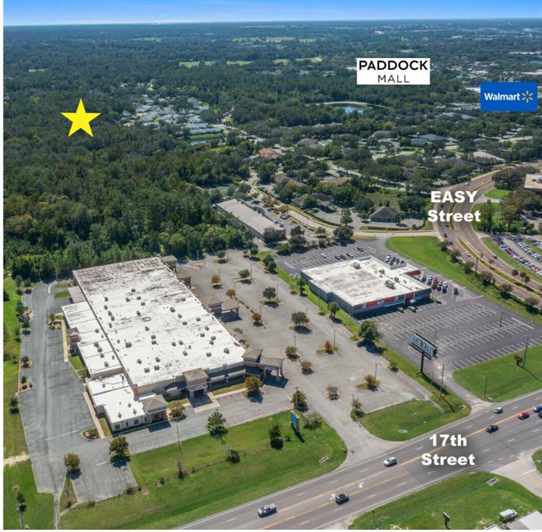 An aerial view shows a commercial property with two buildings, parking lots, and surrounding trees — TBD SW 20TH PLACE, OCALA, FL