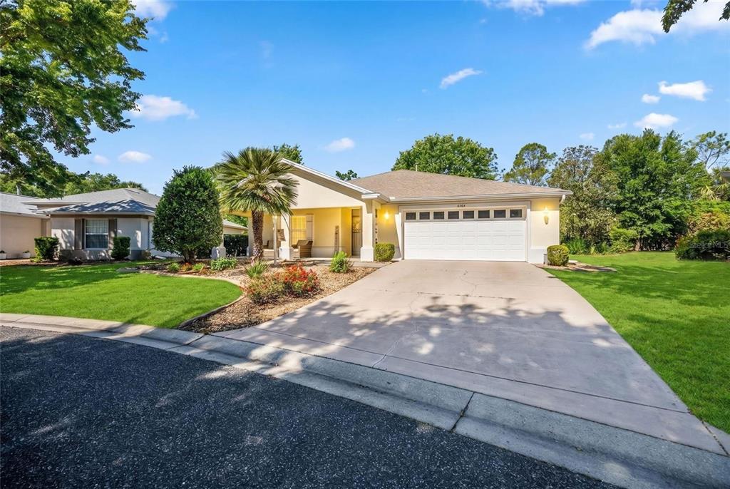 A single-story house with a white garage, a palm tree, and a concrete driveway — 8037 SW 81ST LOOP, OCALA, FL