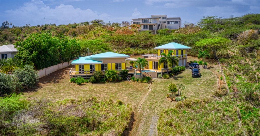 An aerial view of a yellow house with a turquoise roof and a swimming pool — 16 ALTURAS DE ZONI, CULEBRA, PR