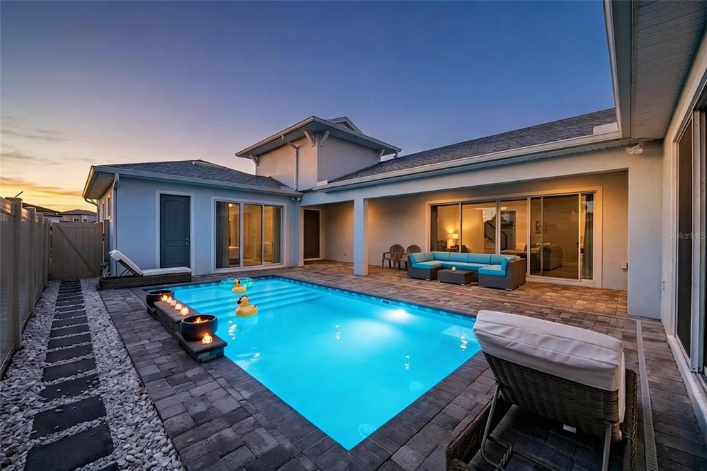 A gray double front door with decorative glass panels sits on a stone porch — 10470 PURPLE THISTLE WAY, SAN ANTONIO, FL