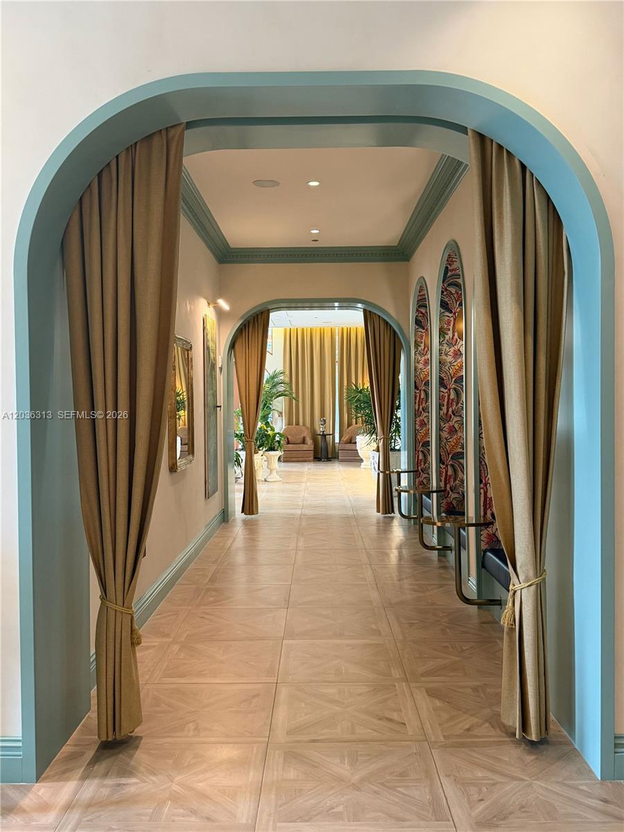 A hallway features arched doorways with teal trim, gold curtains, and patterned wallpaper accents — 2700 NW 2nd Av # 822, Miami FL 33127, MIAMI, FL
