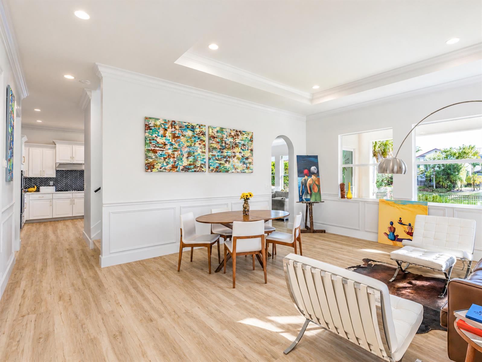 A dining area and living space feature white walls, light wood flooring, and modern furniture — 11990 NW 83rd Place, Parkland FL 33076, PARKLAND, FL