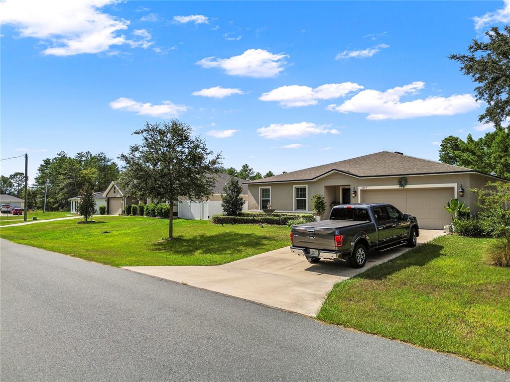 A gray pickup truck is parked in the driveway of a single-story suburban house — 3697 SW 128TH PLACE, OCALA, FL