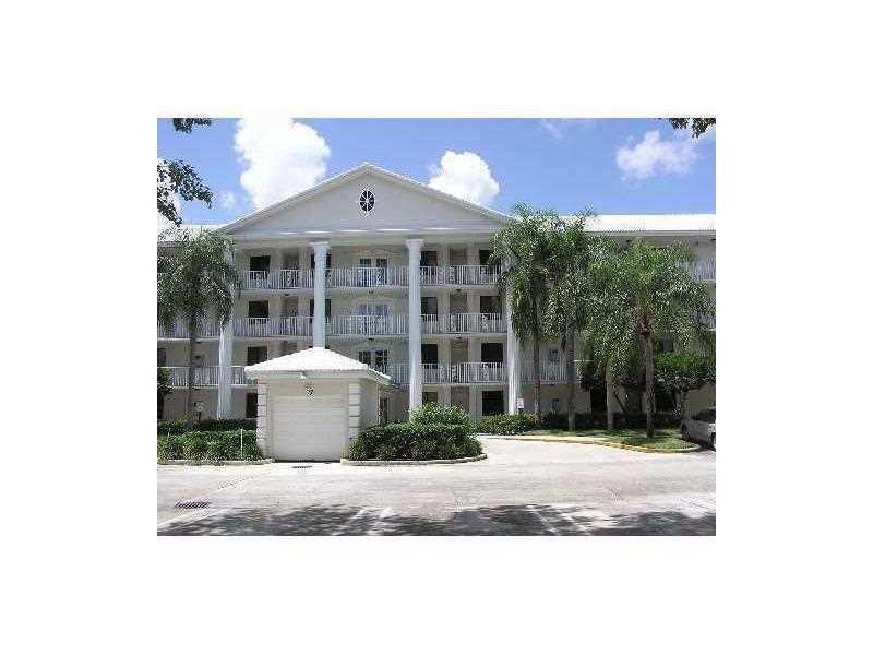 A multi-story apartment building with white columns and a small detached garage in front — 3650 Whitehall Drive # 403, West Palm Beach FL 33401, WEST PALM BEACH, FL
