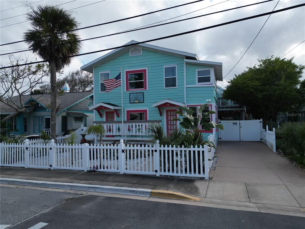 A two-story, light blue house with pink trim and a white picket fence — 434 VERMONT AVENUE, DAYTONA BEACH, FL