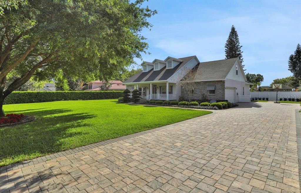 A two-story house with a paved driveway, large front lawn, and three dormer windows — 3831 GAINES DRIVE, WINTER HAVEN, FL