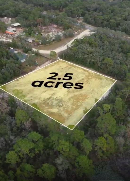 An aerial view shows a cleared, rectangular 2.5-acre plot of land surrounded by dense trees — 7131 KNOXVILLE DRIVE, WEBSTER, FL