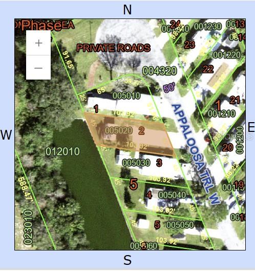 This is a property map showing a highlighted residential lot bordering a canal and road — 26 W APPALOOSA TRAIL, RIVER RANCH, FL