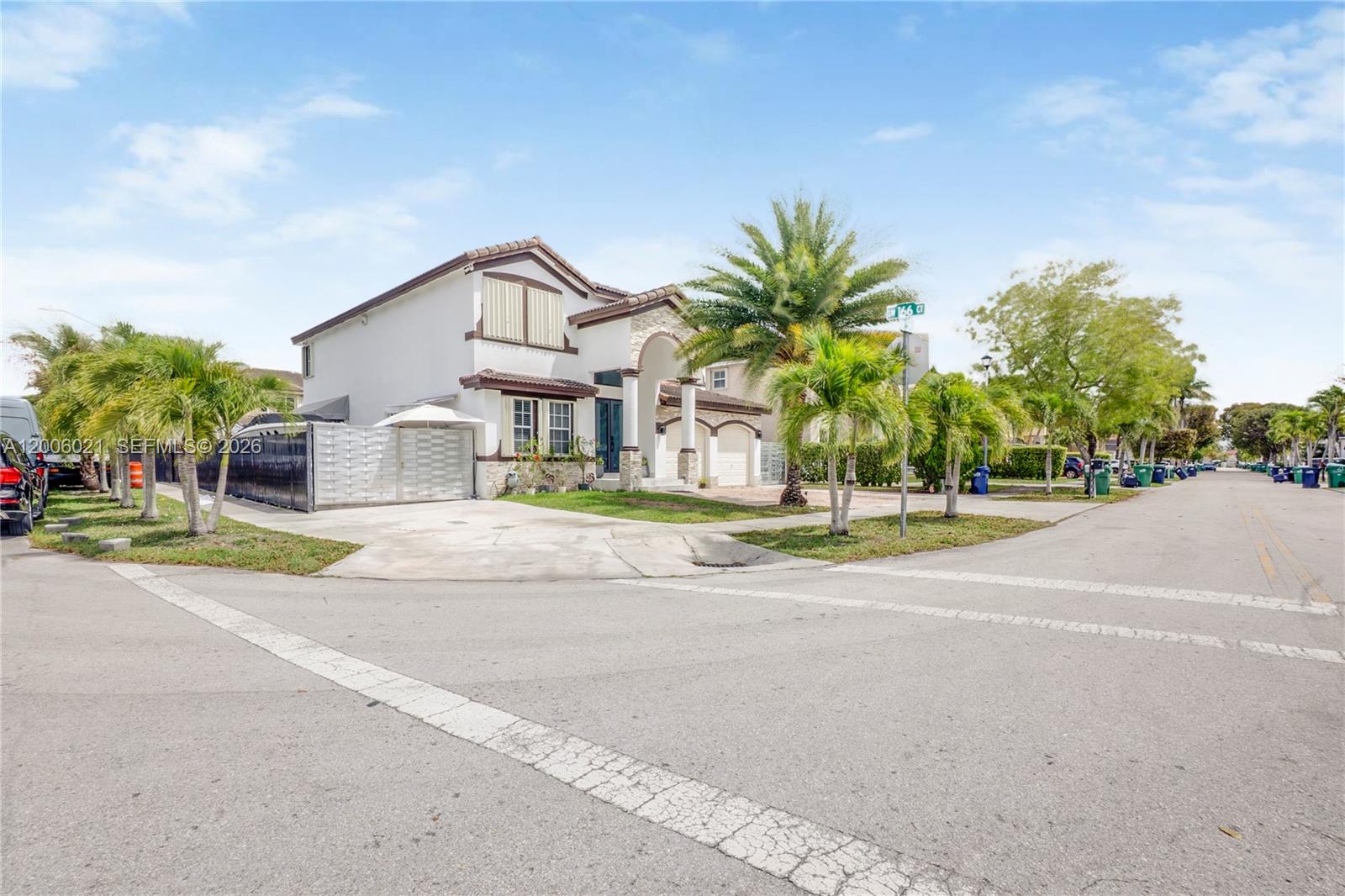 A two-story suburban house with a white exterior, stone accents, and palm trees — 16621 SW 58th Ter, Miami FL 33193, MIAMI, FL