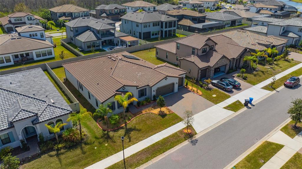 An aerial view of a suburban neighborhood featuring single-family homes with tile roofs — 6167 MARSH TRAIL DRIVE, ODESSA, FL