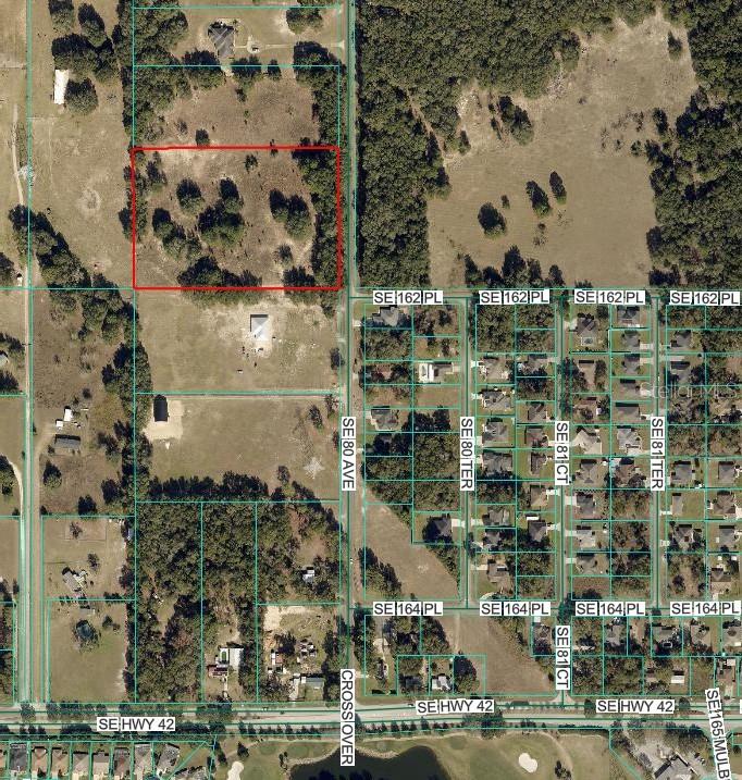 An aerial view shows a rectangular plot of land outlined in red near a road — TBD SE 80TH AVENUE, SUMMERFIELD, FL