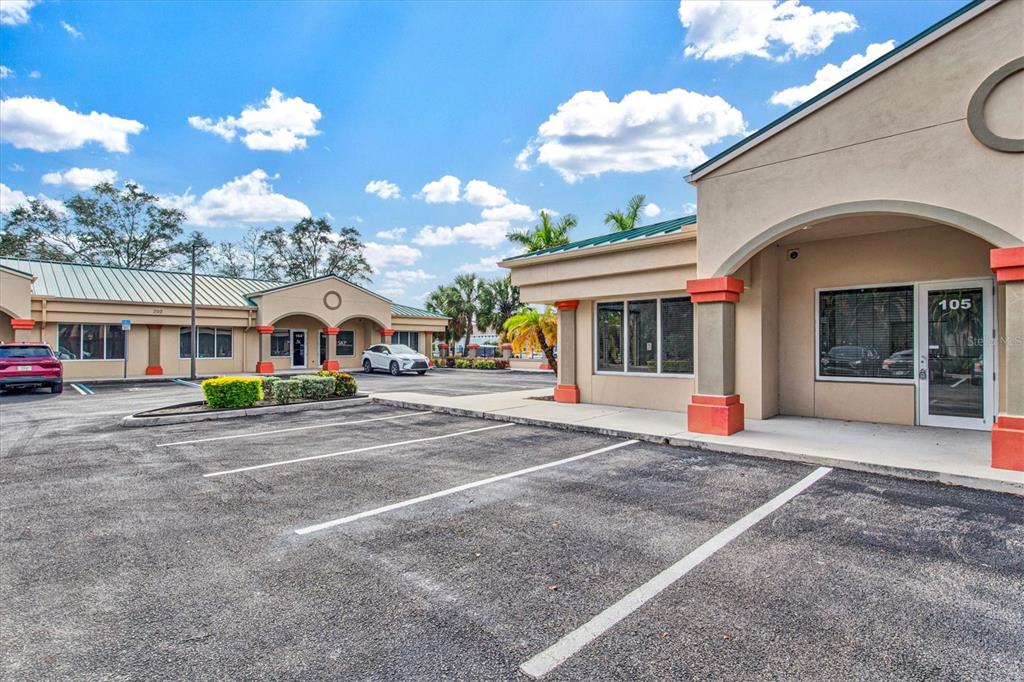 An exterior view of a commercial office building with a parking lot in front — 234 N RHODES AVENUE UNIT 108, SARASOTA, FL