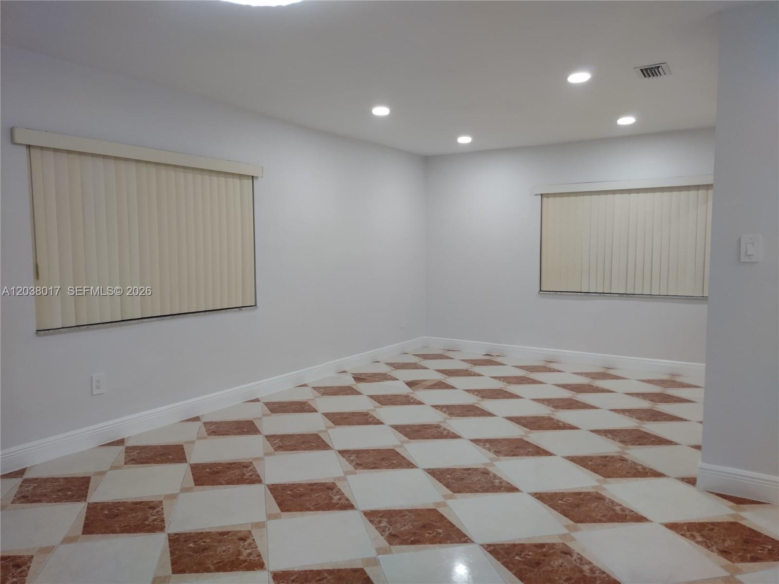An empty room features light gray walls, recessed lighting, and a checkered marble floor — 265 NW 190th St, Miami Gardens FL 33169, MIAMI GARDENS, FL