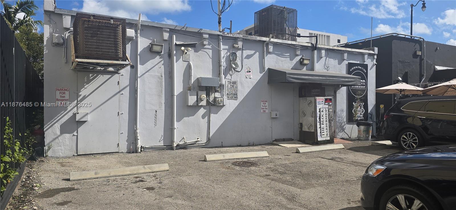 The exterior of a commercial building features a parking lot, signage, and utility equipment — 40 SW 8th Ave, Miami FL 33130, MIAMI, FL