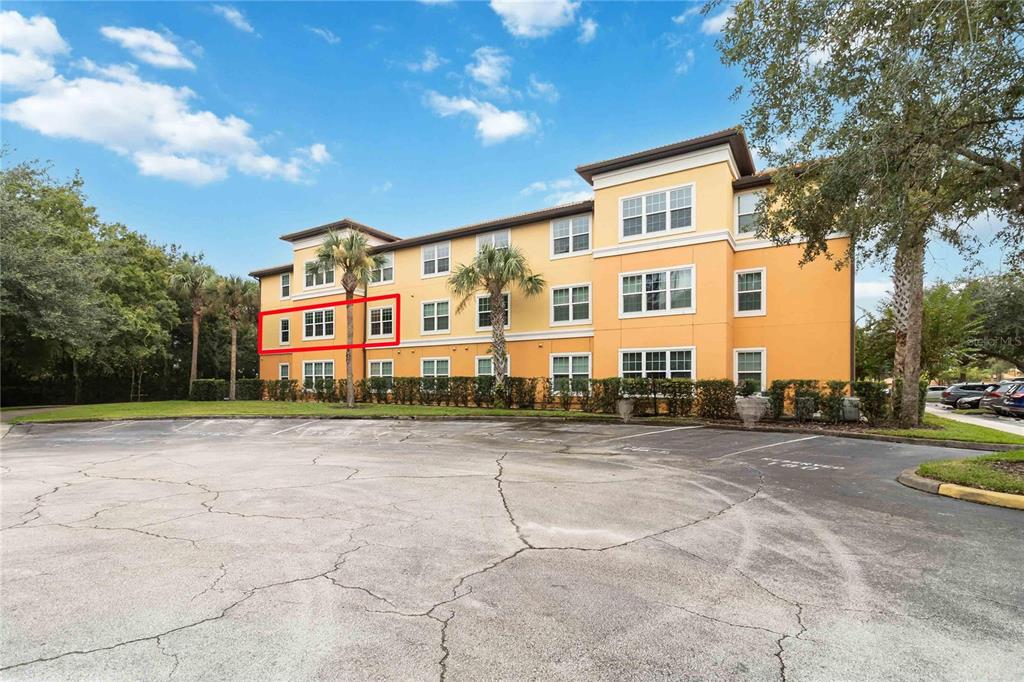 Exterior view of a multi-story apartment building with a red box highlighting specific windows — 5459 VINELAND RD UNIT 4208, ORLANDO, FL