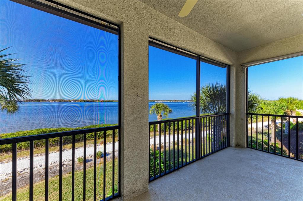 A kitchen features white cabinets, granite countertops, a central island, and three pendant lights — 1246 RIVERSCAPE STREET, BRADENTON, FL
