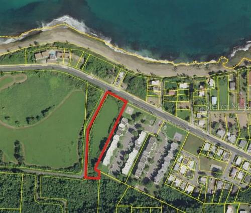This aerial map shows a parcel of land outlined in red near a coastal road — CARR 485 KM 1.7 BO. MEMBRILLO, CAMUY, PR