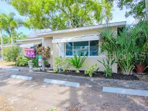 A single-story building with a flat roof, a large window, and landscaping in front — 5617 GULFPORT BOULEVARD S, GULFPORT, FL