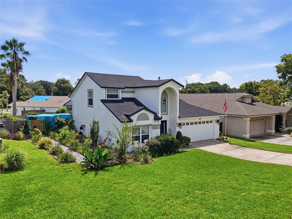 A two-story house with a white exterior, dark roof, and a two-car garage — 2909 SOMERSWORTH COURT, ORLANDO, FL