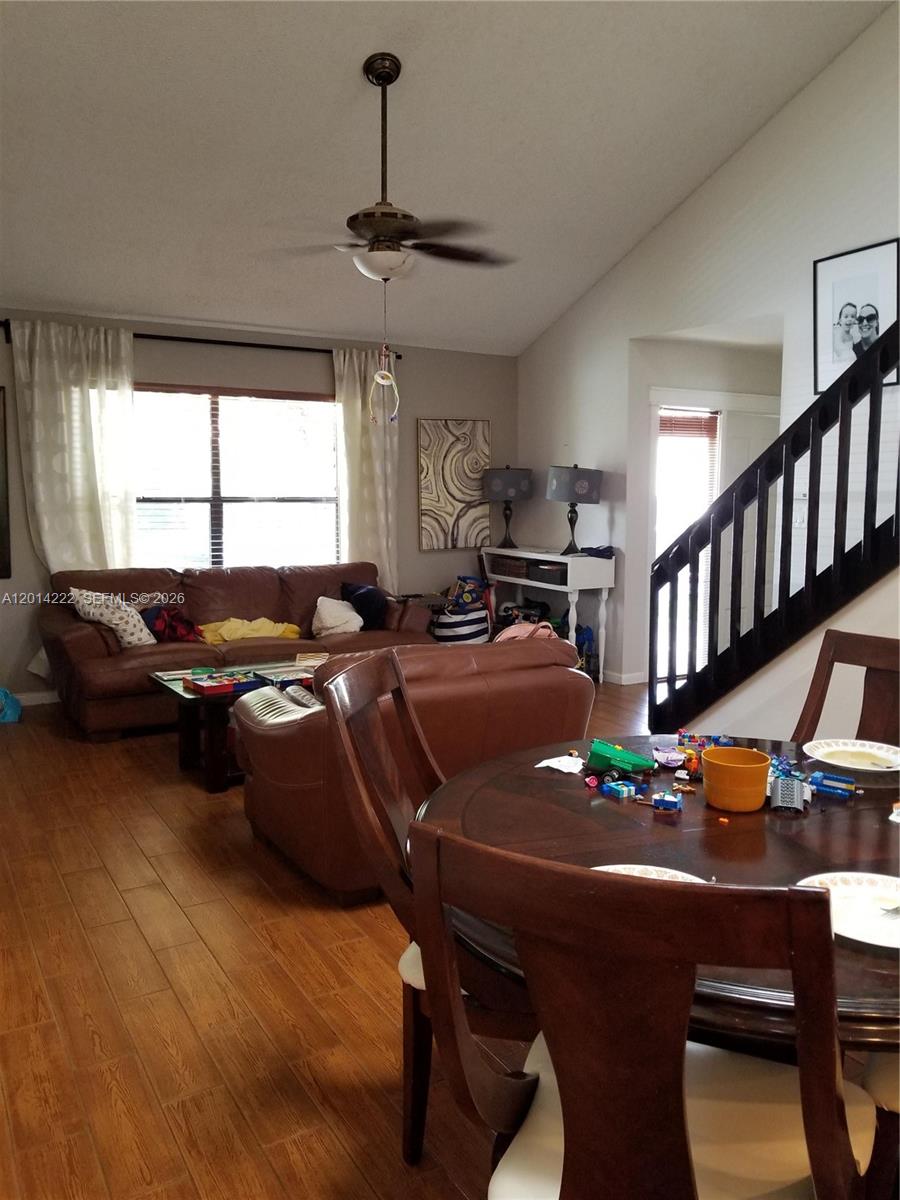 A living room features brown leather sofas, a coffee table, and wood-look tile flooring — 8509 Shadow Ct # 11, Coral Springs FL 33071, CORAL SPRINGS, FL