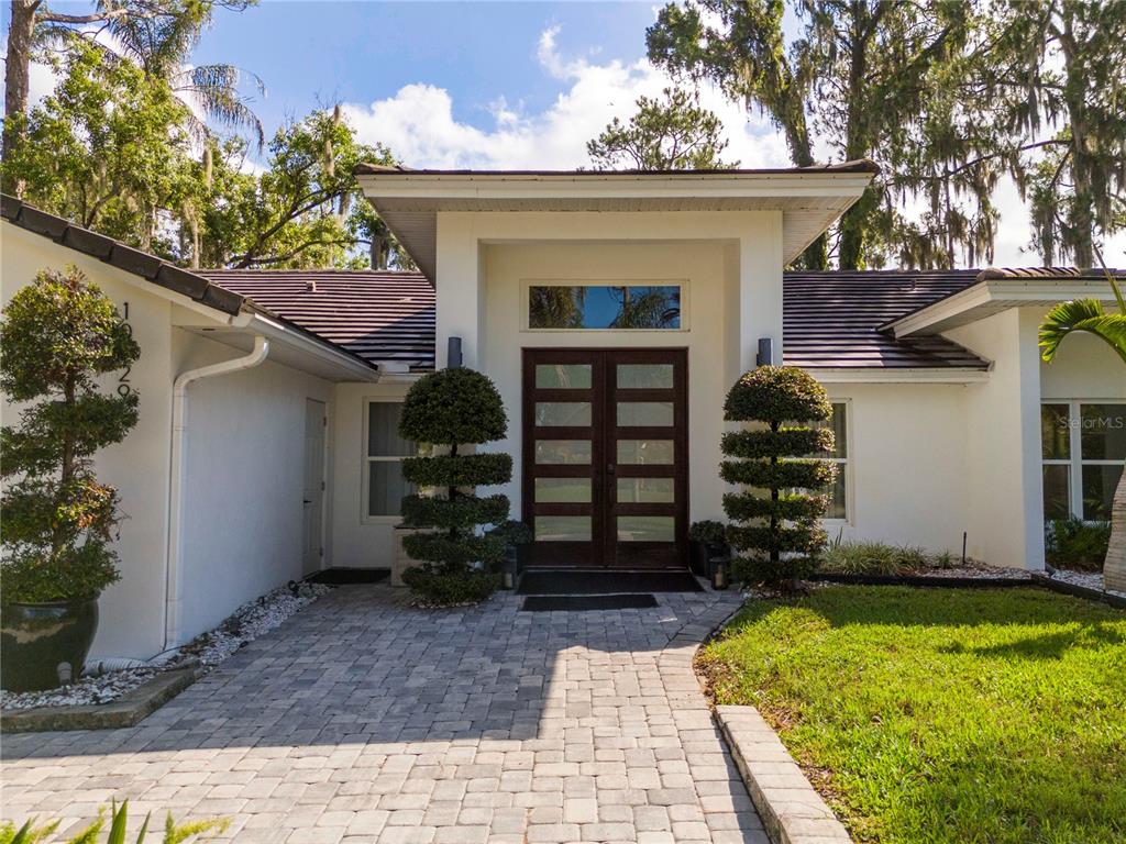 An aerial view shows a house on a triangular lot bordering a large lake — 10129 LONE TREE LANE, ORLANDO, FL